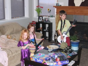 Isabelle, Adelein and Will playing Guitar Hero. 